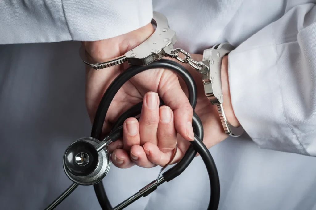 Doctor checks wrist pulse with stethoscope during clinical arm examination.