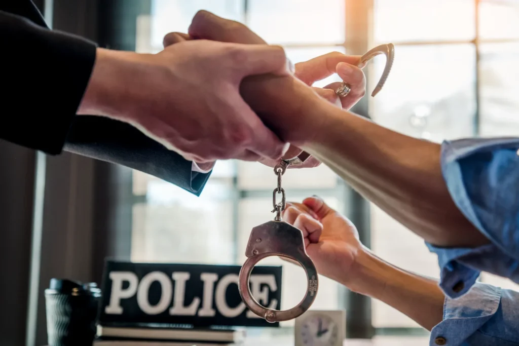 Police keys handoff in close-up hands beneath bold “POLICE” sign